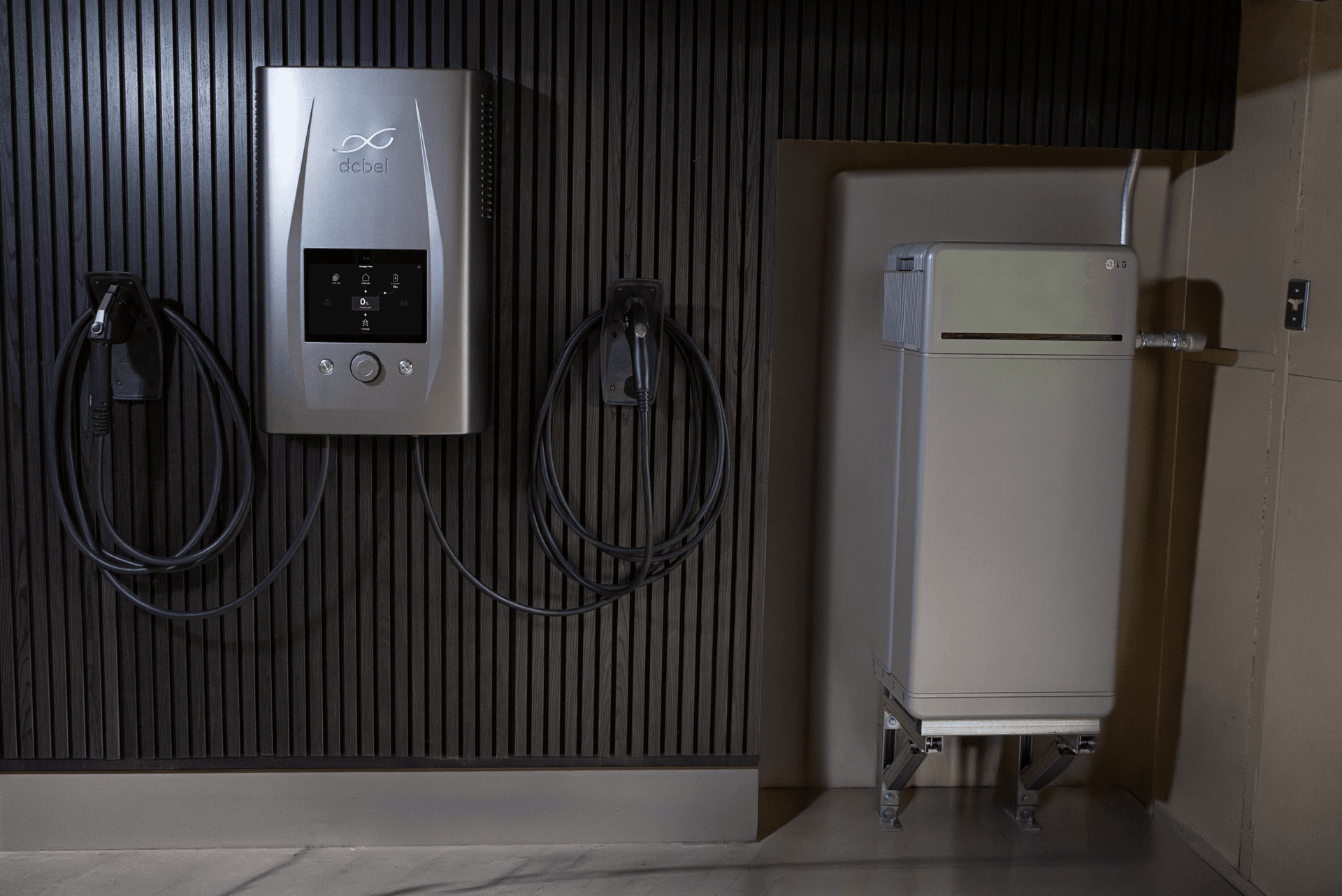Wall-mounted home energy equipment featuring a dcbel energy station and an LG home battery installed side by side, illustrating a residential solar and energy storage setup.
